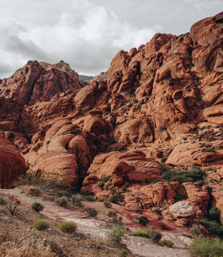 brown rock formation under white clouds during daytime